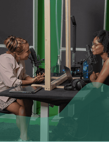 an image of two people recording a podcast in a recording studio